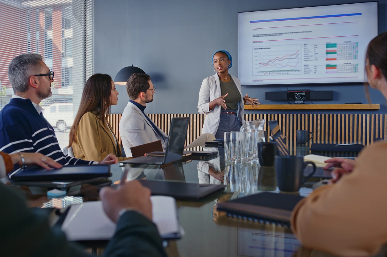 Business, woman and presentation with team in office for training, finance report and data analysis. Speaker, discussion or staff for coaching, financial infographic and revenue statistics of company